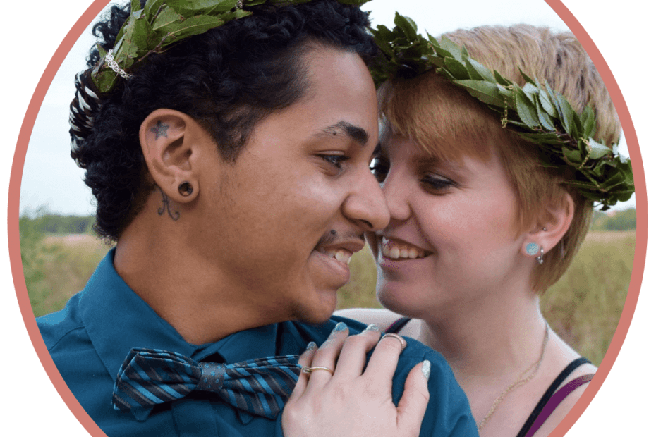 queer alt couple with laurel wreaths in their hair looking romantic