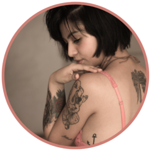 sensual woman with tattoos looking over shoulder