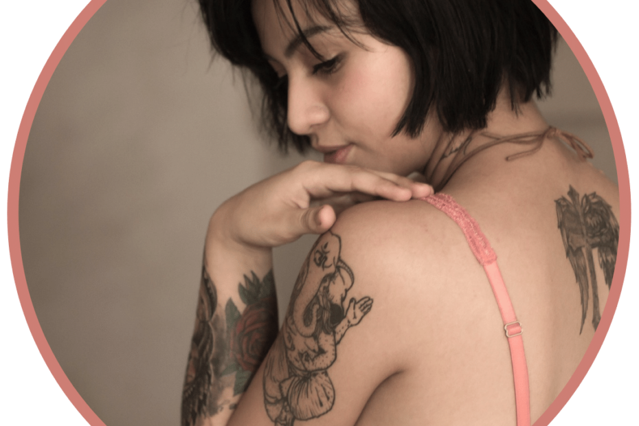 sensual woman with tattoos looking over shoulder