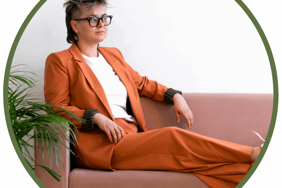 person on couch in orange suit wearing glasses