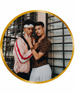 gay men hugging by window