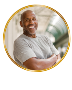 mature man smiling arms folded looking at camera